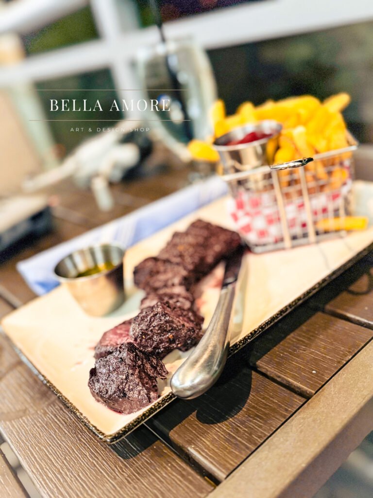 Professional Food photography - picture of a plated steak tips with a basket of French fries